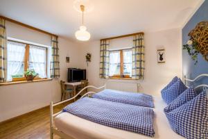 a bedroom with two beds with blue and white pillows at Ferienhaus Annelies in Übersee