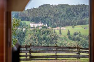 a house on top of a hill with a fence at Appartement Schlern Living 1 in Völs am Schlern