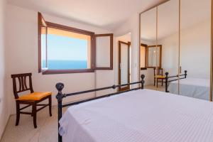 a bedroom with a bed and a window at Villa Sirius - sea view - wellness in Costa Paradiso