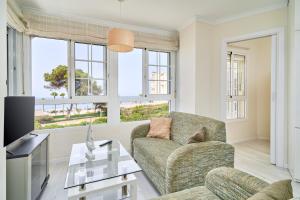 a living room with a couch and a table at Primera línea con terraza A104 in Torrox