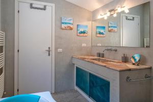 a bathroom with a sink and a mirror at Villa Sirius - sea view - wellness in Costa Paradiso +19 photos