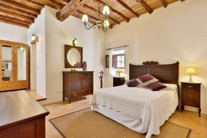 a bedroom with a large bed and a mirror at Can Caseres in Santa Eularia des Riu +32 photos