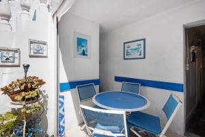 a dining room with a blue table and chairs at Casa dos Afectos - Costa Nova in Gafanha da Encarnação +20 photos