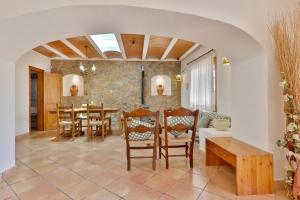 a kitchen and dining room with a table and chairs at Can Caseres in Santa Eularia des Riu
