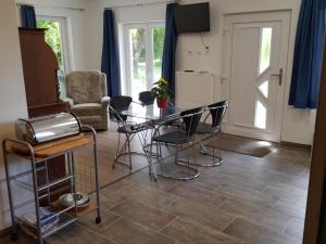 a living room with a table and chairs and a door at Bodensee-Landurlaub in Deggenhausertal +19 photos