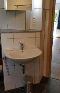 a white sink in a bathroom with a mirror at Bodensee-Landurlaub in Deggenhausertal