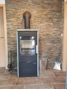 a brick wall with an oven in a room at Bodensee-Landurlaub in Deggenhausertal