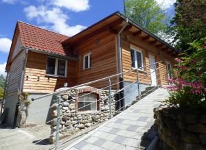 a wooden house with a staircase leading up to it at Bodensee-Landurlaub in Deggenhausertal