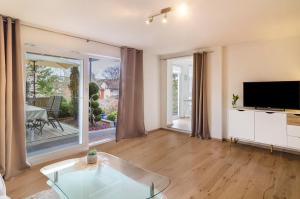 a living room with a tv and a large window at Ferienwohnung Kunstmann in Überlingen