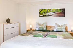 a bedroom with a bed and two pictures on the wall at Ferienwohnung Kunstmann in Überlingen