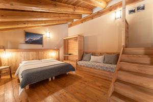 a bedroom with a bed and a couch at Civico 6 in Marmora