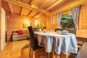 a dining room with a table and a couch at Hütte im Heidekreis in Lindwedel +14 photos