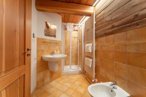 a bathroom with a sink and a shower and a toilet at Civico 6 in Marmora +7 photos