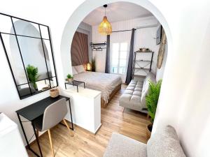 a room with a bed and a table and a couch at aeolian blu 6 in Parikia
