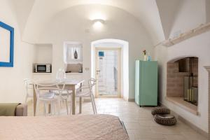 a kitchen with a table and a green refrigerator at Arco Antelmy in Ceglie Messapica