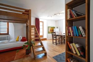 a bedroom with two bunk beds and a dining room at Klostermeisterhaus in St. Blasien