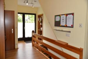 a hallway with a stairway with a stair railing at Ferienwohnung Dürnbach in Albstadt +3 photos