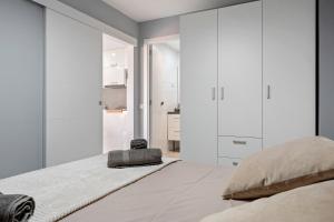 a bedroom with white walls and a large bed at Calafenga in Calafell