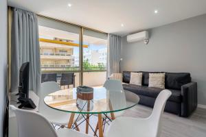 a living room with a glass table and a couch at Calafenga in Calafell +12 photos