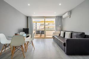a living room with a black couch and a table at Calafenga in Calafell