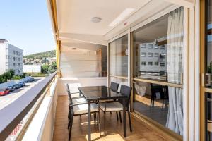 a balcony with a black table and chairs on it at Calafenga in Calafell