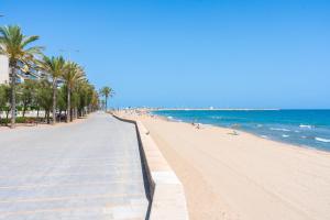 a view of a beach with palm trees and the ocean at Calafenga in Calafell