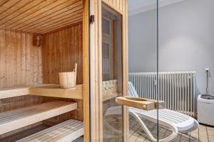 a sauna with a bench and a chair in a room at Schwarzwaldliebe mit Pool, Sauna in Schönwald +26 photos