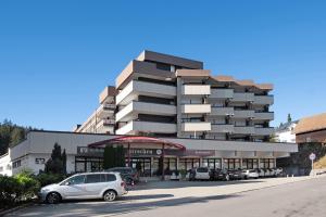 a parking lot in front of a building at Schwarzwaldliebe mit Pool, Sauna in Schönwald
