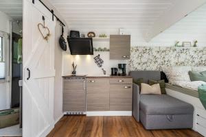 a tiny house with a kitchen and a living room at Amselnest in Dobeneck