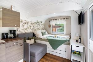 a small kitchen with a table in a tiny caravan at Amselnest in Dobeneck