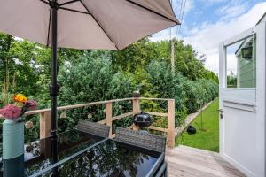 an umbrella on the deck of a house at Amselnest in Dobeneck