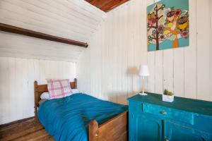 a bedroom with a bed and a blue cabinet at Maison Pleneuf Val André Plage 5min in Pléneuf-Val-André
