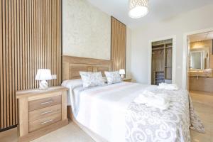 a bedroom with a large bed with a wooden headboard at Cala alta in Benidorm +33 photos