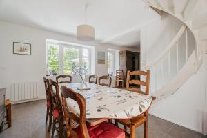 a dining room with a table and chairs at Maison Pleneuf Val André Plage 5min in Pléneuf-Val-André +17 photos