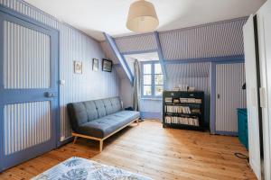 a living room with a couch and a window at Maison Pleneuf Val André Plage 5min in Pléneuf-Val-André