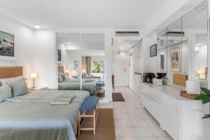 a hotel room with two beds and a bathroom at Miraflores A112 in La Cala de Mijas +13 photos