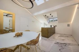 a room with a white table with a stuffed animal on it at App 301 Palazzo Cavour in Bolzano +16 photos