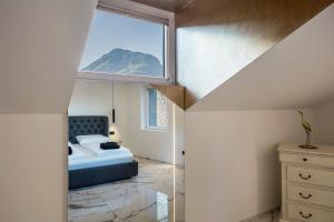 a small bedroom with a bed and a window at App 301 Palazzo Cavour in Bolzano