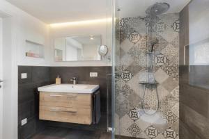 a bathroom with a sink and a shower at Fewo Feldmann Auf Der Mauer in Schmallenberg +16 photos