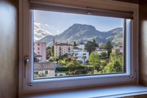 a window with a view of a mountain at App 301 Palazzo Cavour in Bolzano