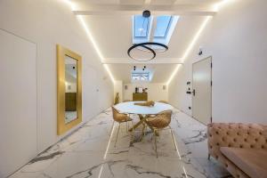 a dining room with a table and a couch at App 301 Palazzo Cavour in Bolzano