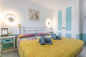 a bedroom with a large bed with a yellow blanket at Relax Holidays Corralejo in Corralejo