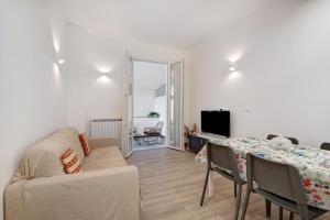 a living room with a table and a couch at Moneglia Monte in Moneglia