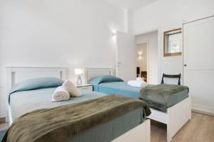 a bedroom with two beds and a mirror at Moneglia Monte in Moneglia