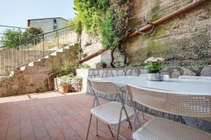 a white table and chairs on a patio at Moneglia Monte in Moneglia