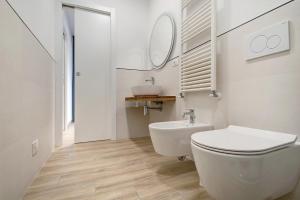 a white bathroom with a toilet and a sink at Moneglia Monte in Moneglia +19 photos