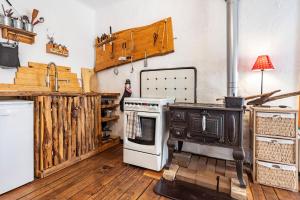 a kitchen with an oven and a stove at Casa del Sol - Fachwerkhäuschen in Lychen +26 photos