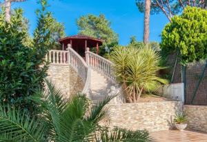 a staircase in a garden with a gazebo at Costacabana - Villa Primadonna in Lloret de Mar