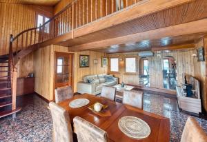 a dining room with a table and a couch at Costacabana - Villa Primadonna in Lloret de Mar