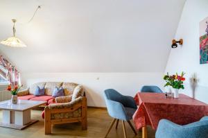 a living room with a couch and a table at Ferienwohnungen Kopp in Hagnau
